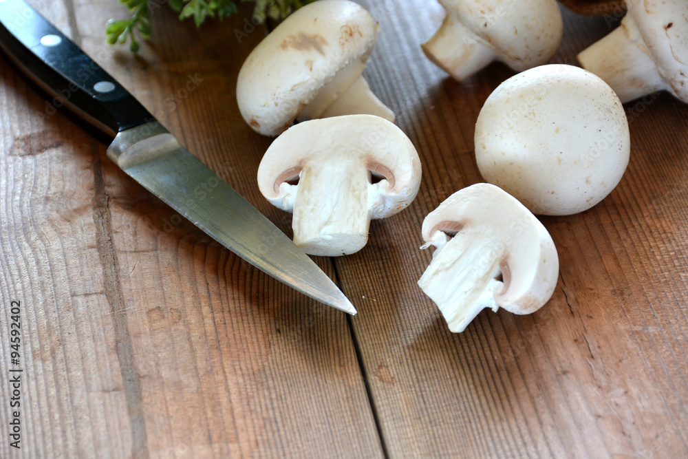 VARIOUS MUSHROOMS placed on a wooden table VARIOUS MUSHROOMS placed on a wooden table
