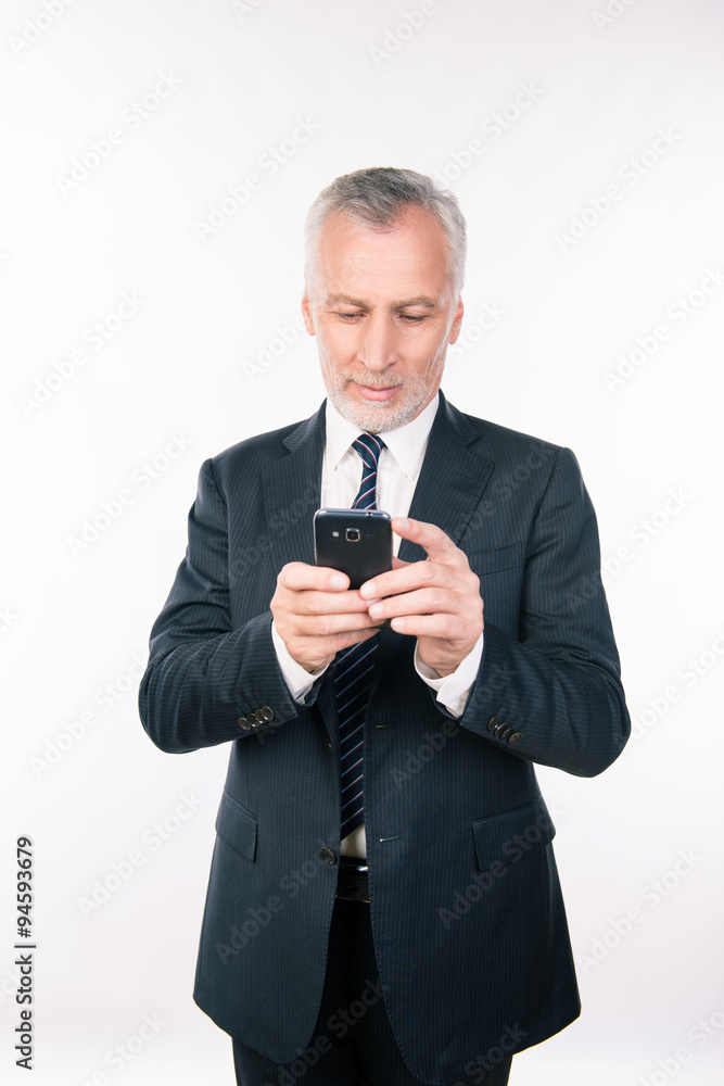 Old handsome businessman working with his smartphone Old handsome businessman working with his smartphone