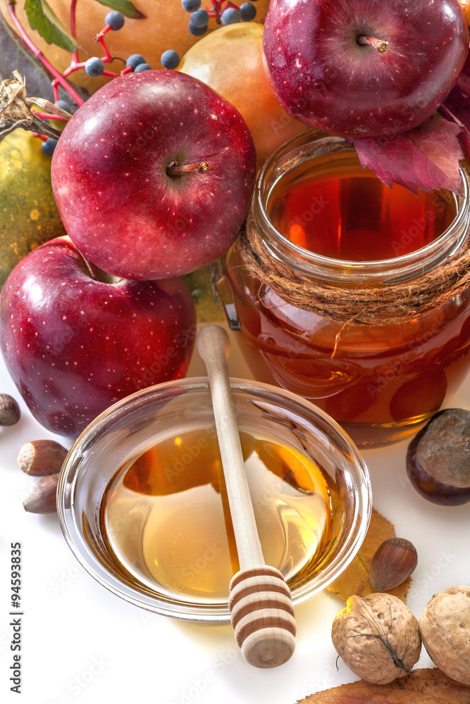 Honey, apples and autumn fruits on the white background Honey, apples and autumn fruits on the white background