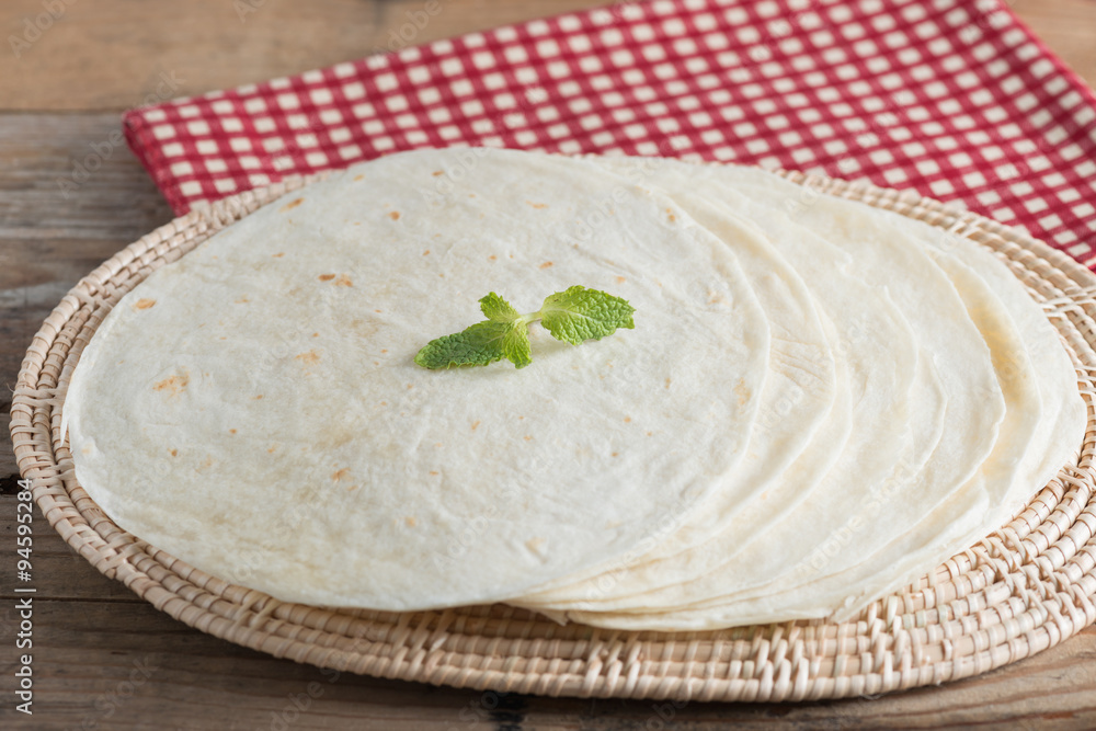 Homemade whole wheat flour tortillas on wooden table. Homemade whole wheat flour tortillas on wooden table.