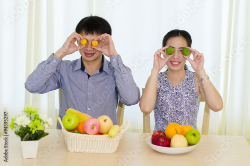 Portrait of young Asian couple with fruits, healthy eating concept