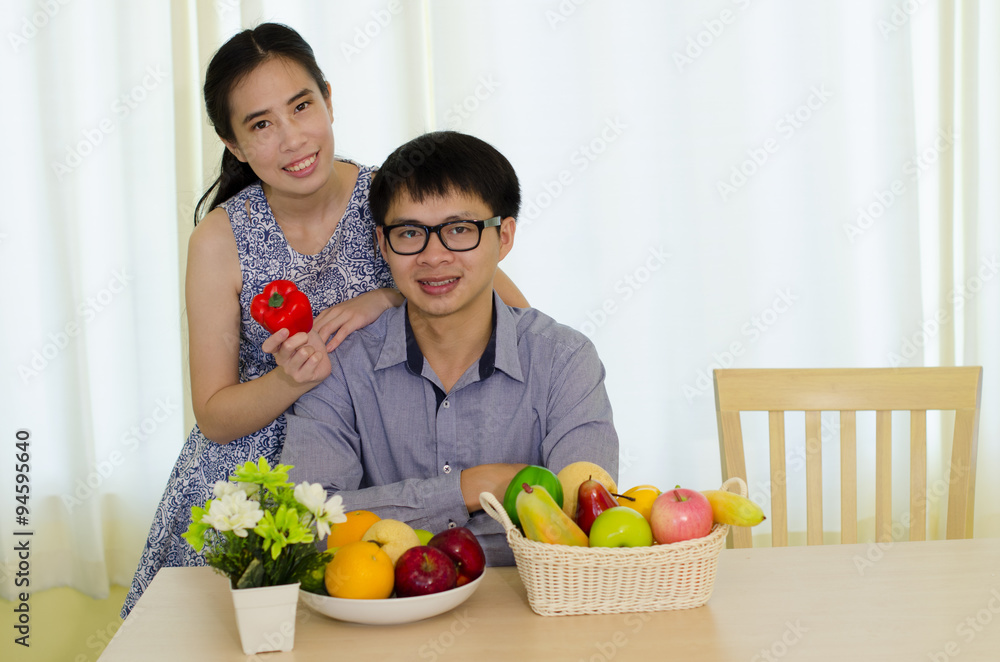 Portrait of young Asian couple with fruits, healthy eating concept Portrait of young Asian couple with fruits, healthy eating concept