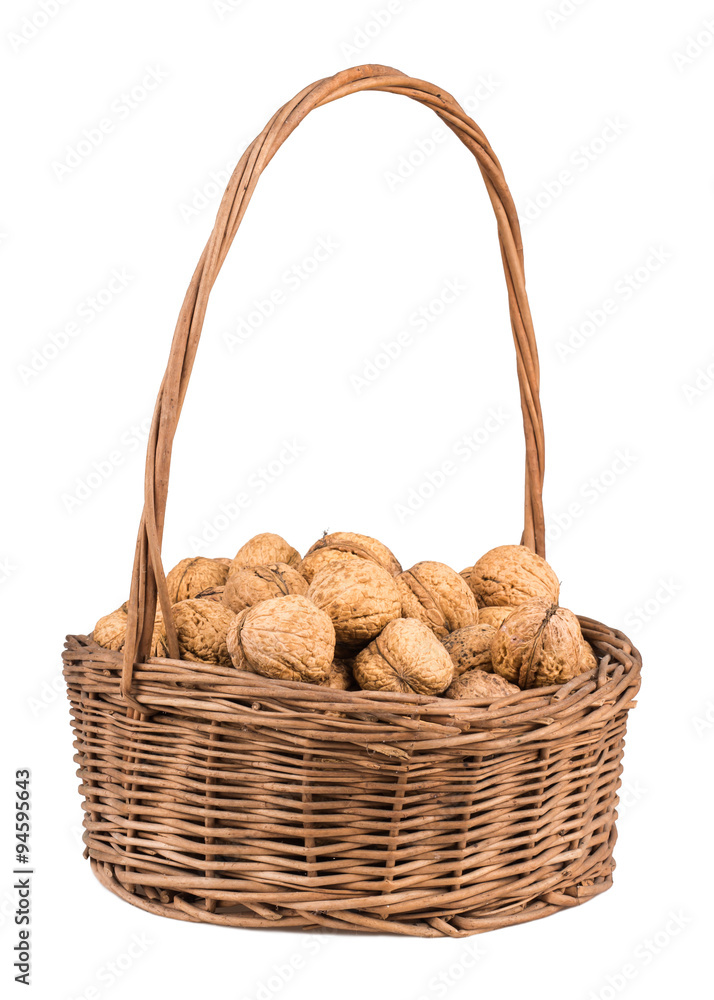 wicker basket with walnuts isolated on a white background wicker basket with walnuts isolated on a white background