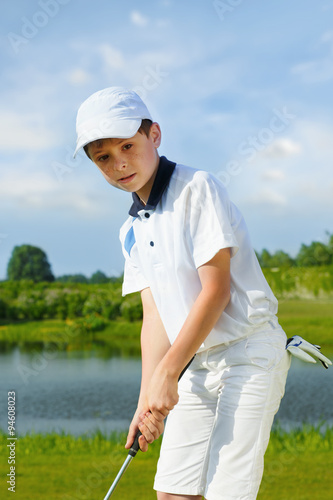 Boy playing golf © Iurii Sokolov