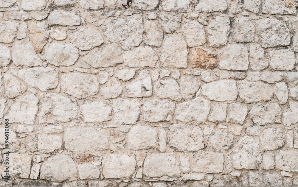 Old wall made of irregular limestone stones Old wall made of irregular limestone stones