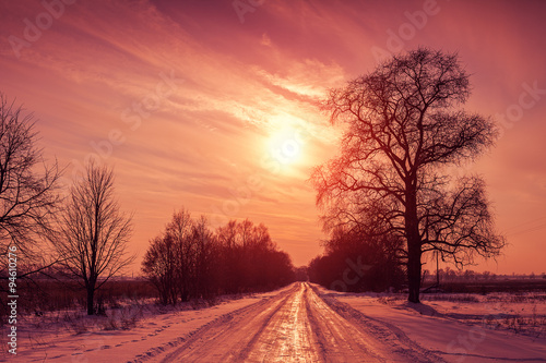 Sunset over snowy road