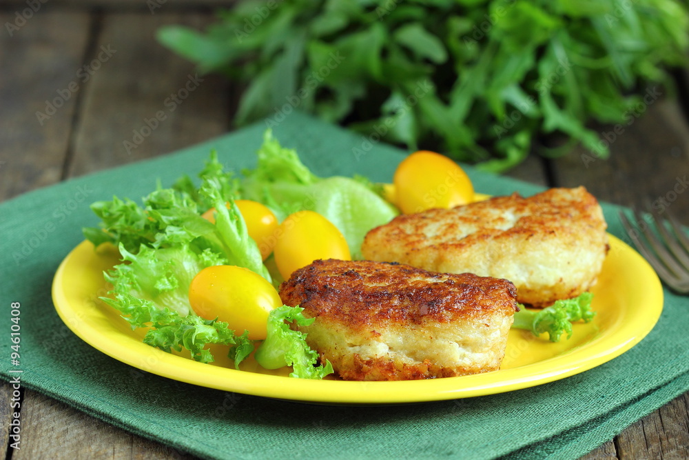 Cod fish cakes served with a salad. Cod fish cakes served with a salad.