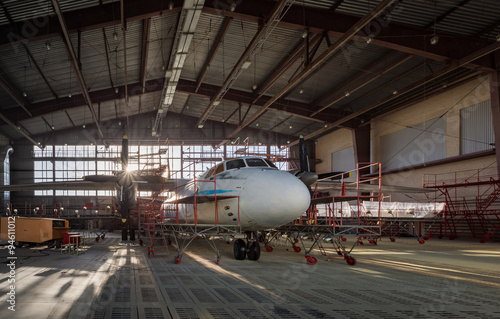 Aircraft stands on repair in aviation hangar