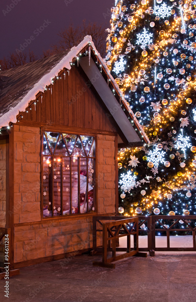 Christmas tree and wooden Santa's house