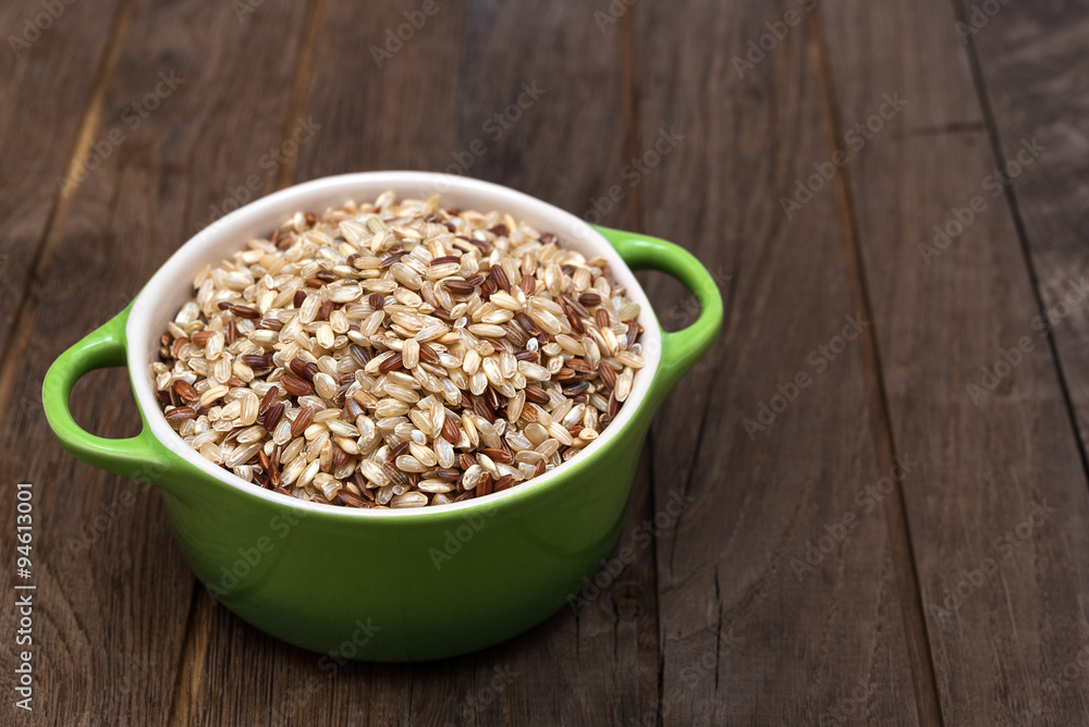 Raw brown rice in ceramic pot Raw brown rice in ceramic pot