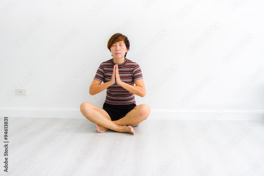 Smart Asian woman meditating indoors at home. Smart Asian woman meditating indoors at home.