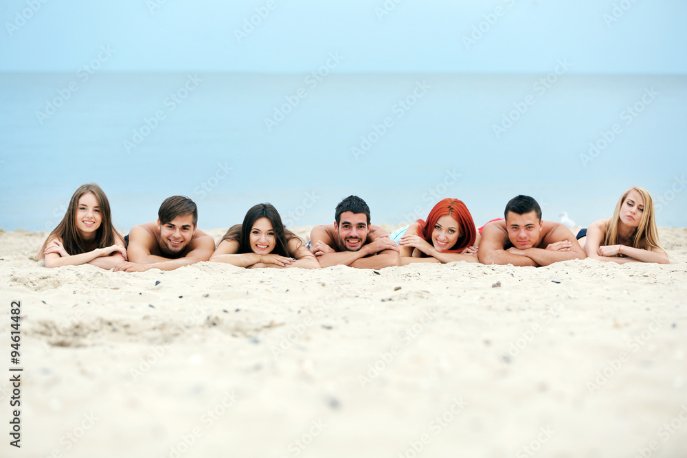 Beautiful young people lying on beach Beautiful young people lying on beach