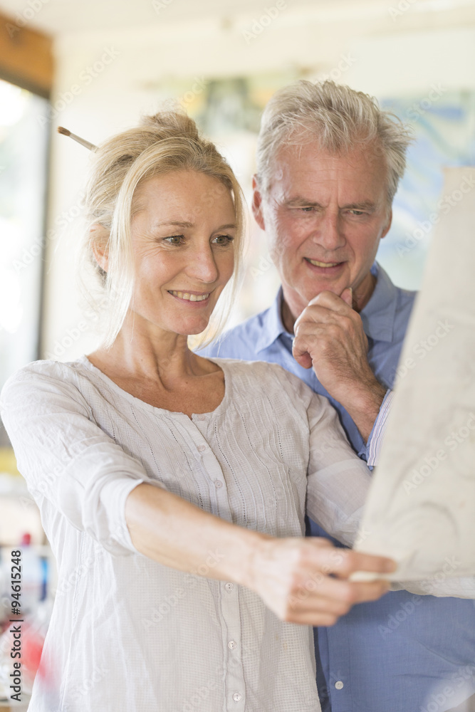 mature couple while painting on a canvas mature couple while painting on a canvas