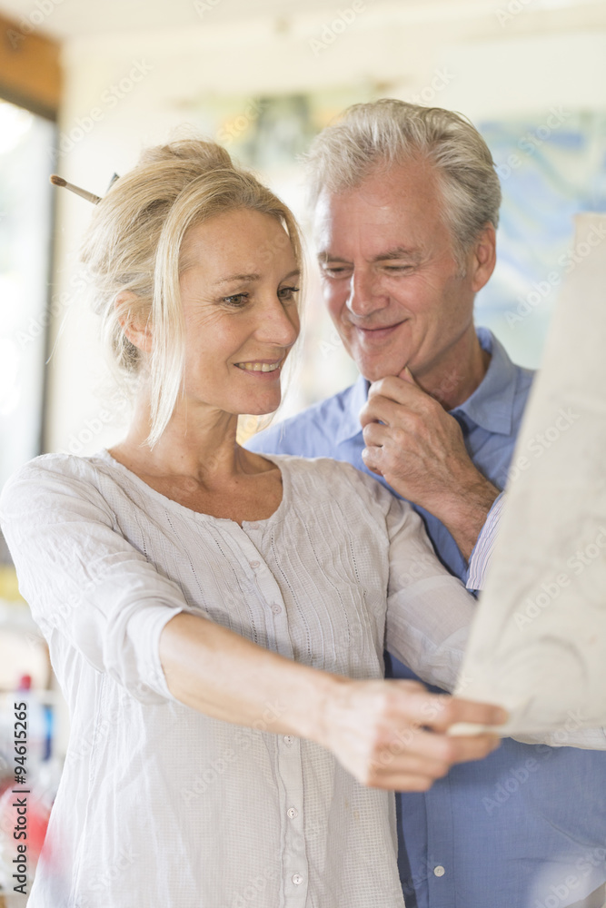 mature couple while painting on a canvas mature couple while painting on a canvas