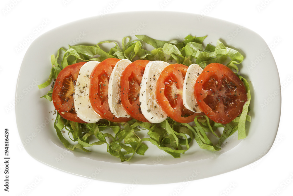 Italian salad - Caprese salad, tomato and mozzarella with spices, served on a white plate. Isolated on white. Italian salad - Caprese salad, tomato and mozzarella with spices, served on a white plate. Isolated on white.