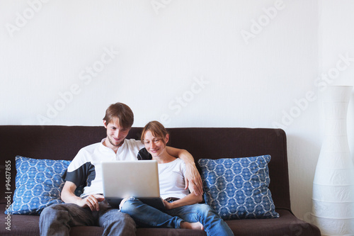 couple with laptop at home