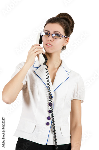 Young woman secretary talking on the phone. Isolated on white photo