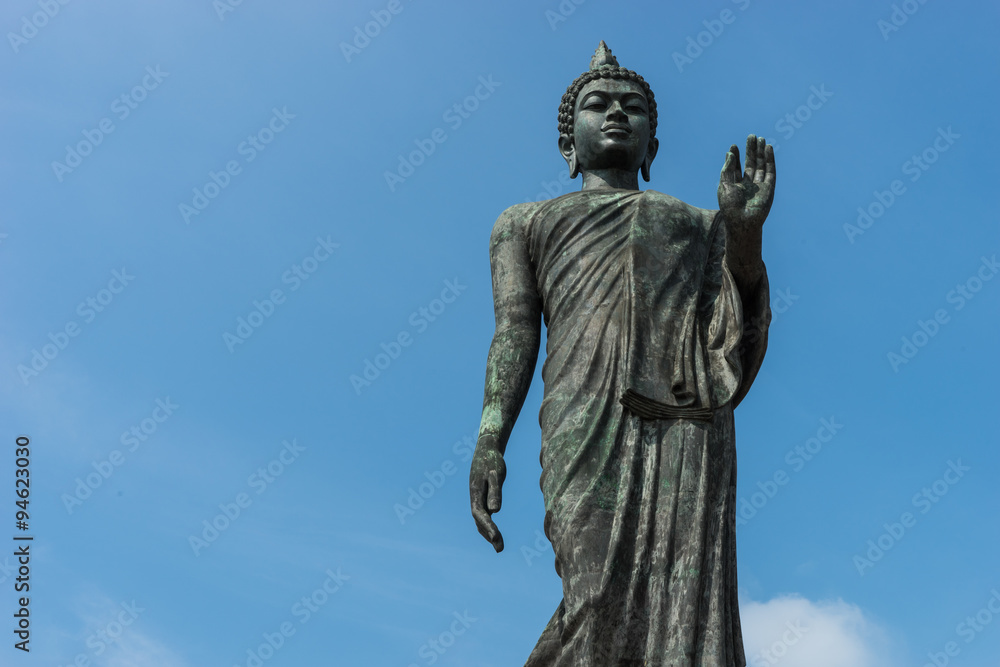 Standing Buddha statue and sky backgroud in Thailand