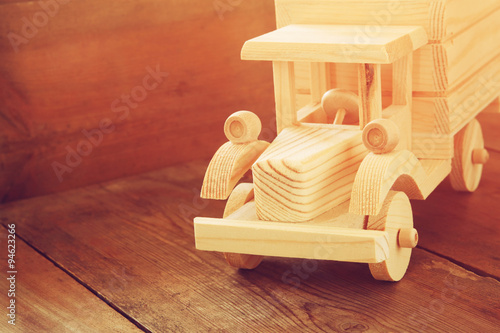 retro wooden toy car over wooden table. room for text. nostalgia and simplicity concept. retro style image
