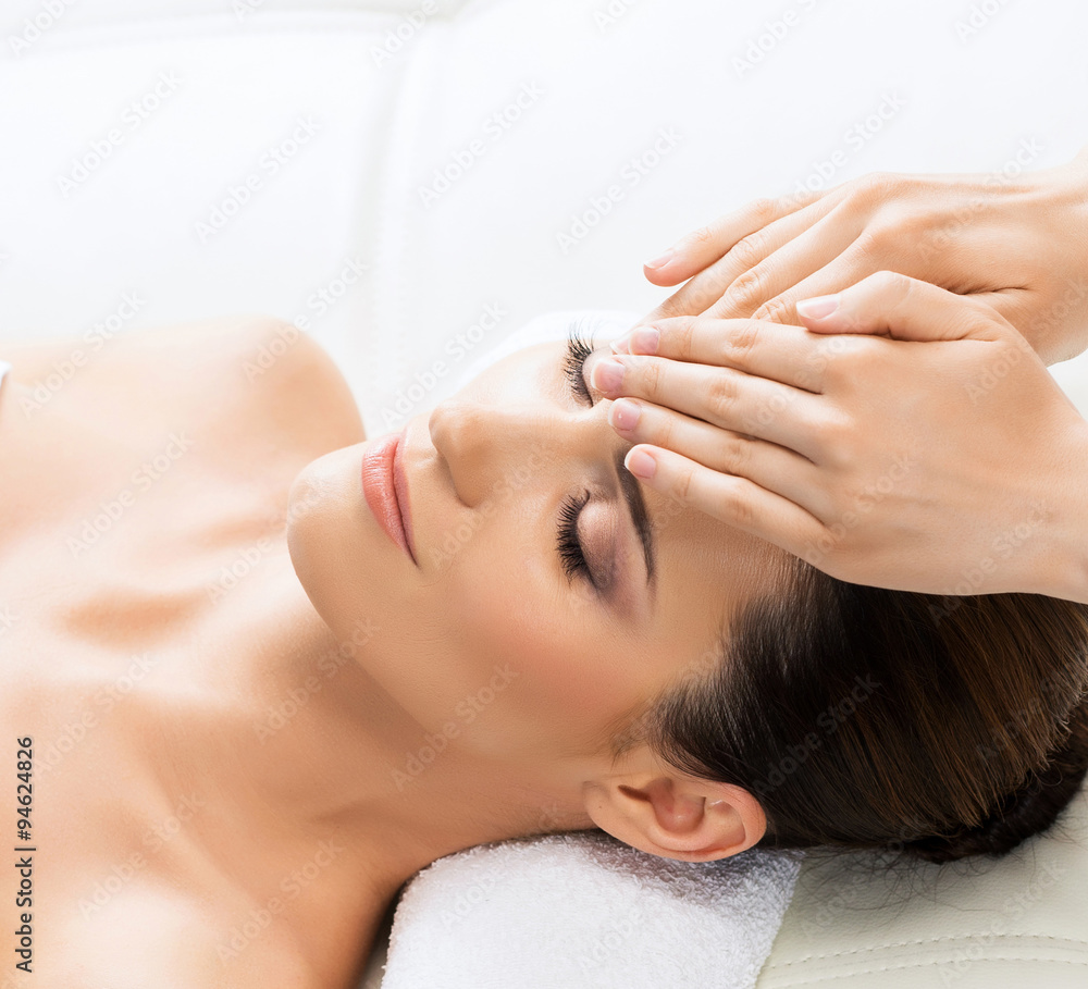 Beautiful woman laying on a mat in massage salon.