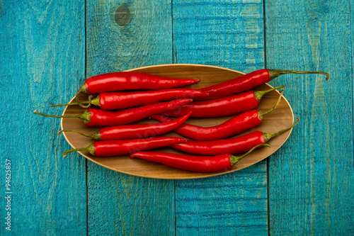 fresh red chili pepper on old blue wooden background