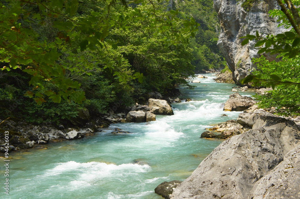 The mountain river flowing among the rocks in summer The mountain river flowing among the rocks in summer
