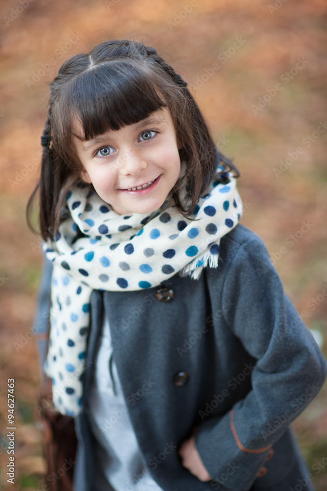 girl in coat and scarf smiling