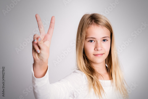 nice blond girl showing victory sign