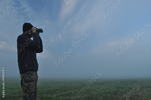 Man involved in sport in the morning. Meadow in the mist.