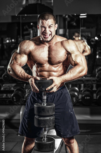 Bodybuilder muscle Athlete training with weight in gym © Fotokvadrat