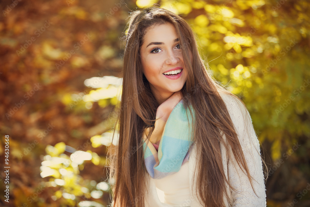 Excited happy woman smiling joyful and blissful holding autumn leaves outside in colorful fall forest Excited happy woman smiling joyful and blissful holding autumn leaves outside in colorful fall forest