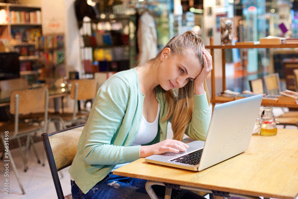 Female student sitting in class with laptop Female student sitting in class with laptop