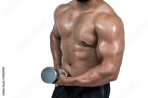 Muscular man lifting heavy dumbbell 