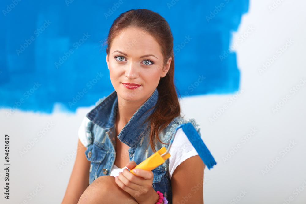 Beautiful young woman doing wall painting Beautiful young woman doing wall painting