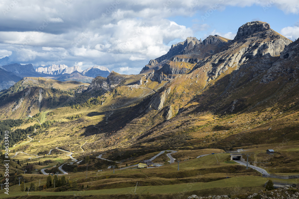 View of mountain path in alpine valley in autumn season, Passo Pordoi, Dolomites Mountains, Italy