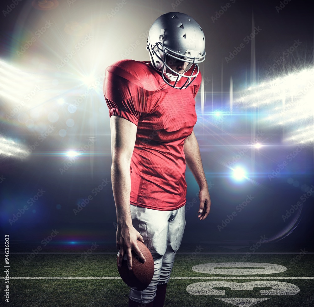 Composite image of american football player looking down