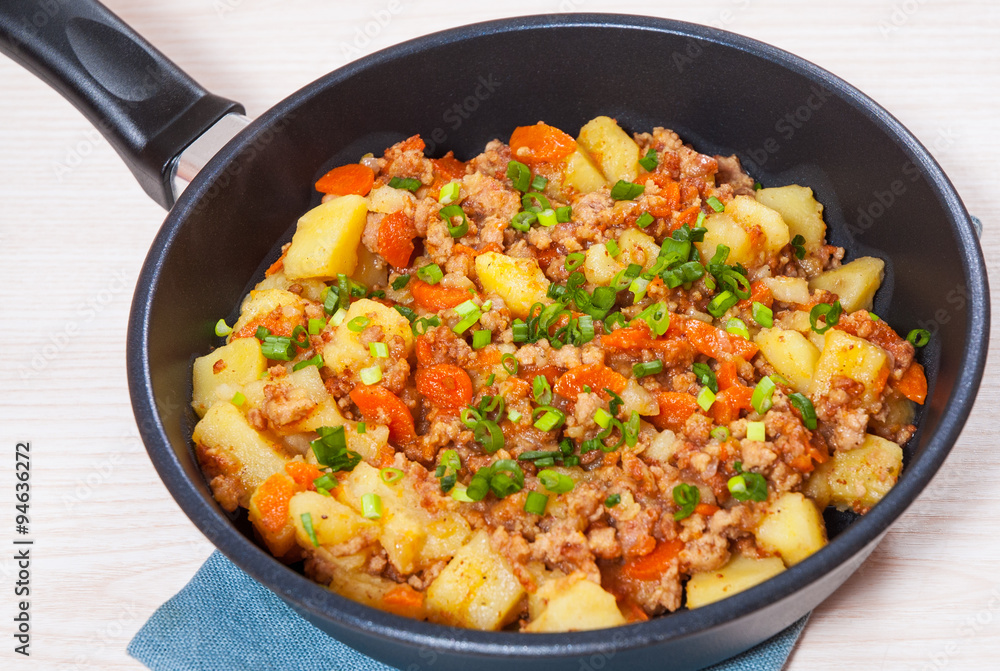 stewed potato with minced meat in a frying pan stewed potato with minced meat in a frying pan