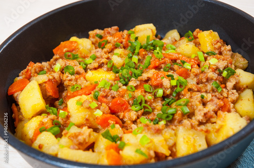 stewed potato with minced meat in a frying pan