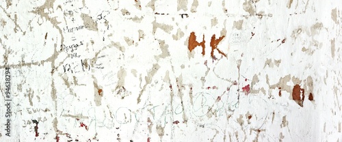 Фотография Scratched By Vandals Old Whitewashed Walls With Many Signs