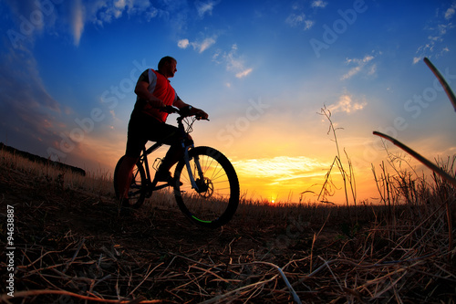 Silhouette of a man on muontain-bike