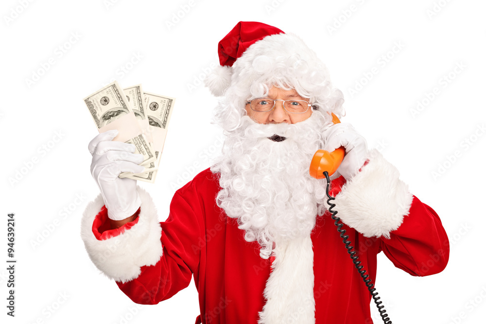 Santa Claus talking on phone and holding money Santa Claus talking on phone and holding money