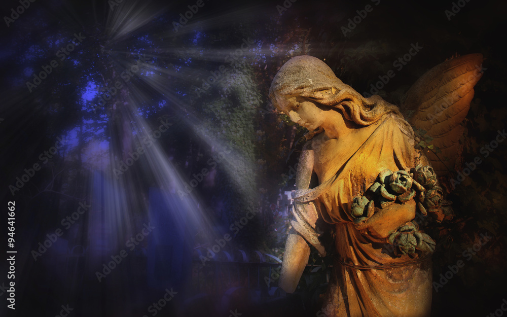 Fototapeta premium Majestic view of statue of golden angel illuminated by light aga