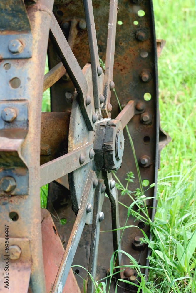 Rusty iron wheel from an old tractor Rusty iron wheel from an old tractor