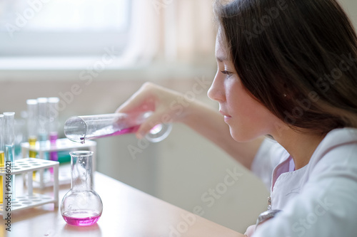 Schoolgirl or student  in science class photo