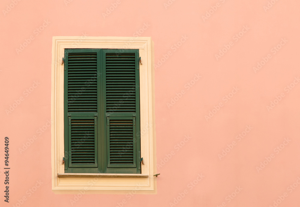 old closed wooden shutters isolated on the exterior of the house wall