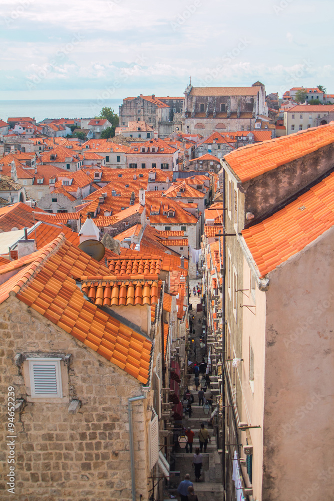 Narrow street, roofs and old houses in old town Dubrovnik, Croatia, panoramic view 
