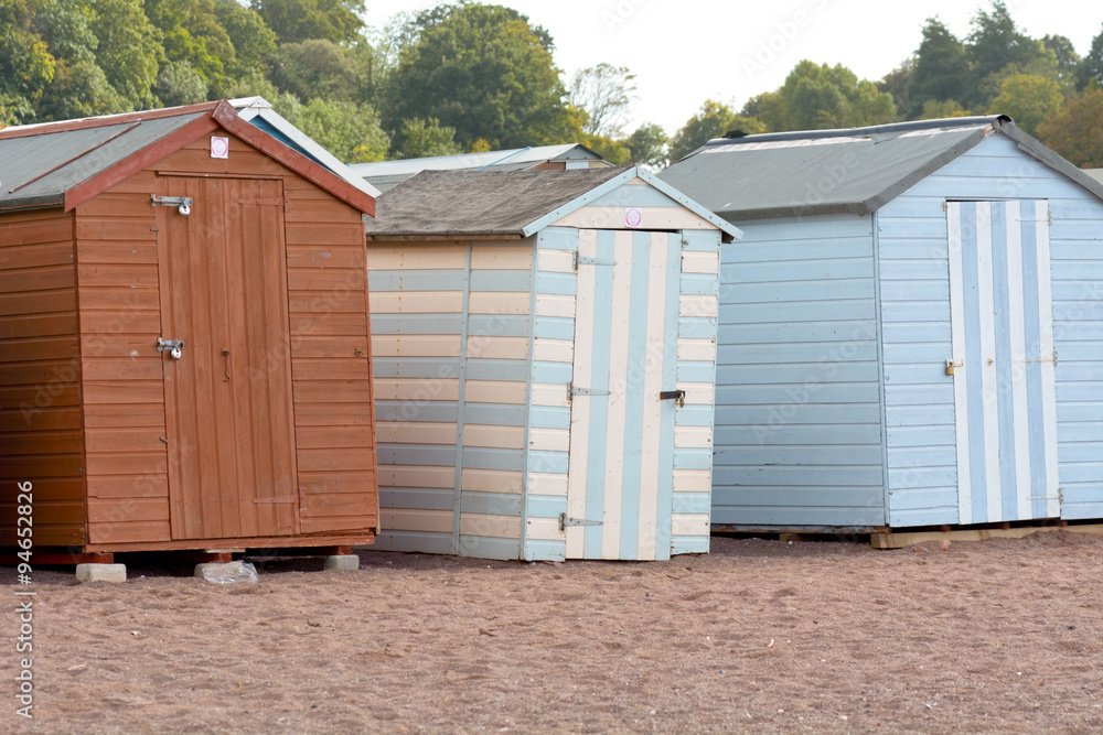 A row of wooden beach huts in Teignmouth, Devon, England A row of wooden beach huts in Teignmouth, Devon, England
