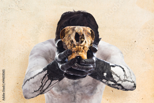 Canvas Print Primitive man offering a rabbit skull