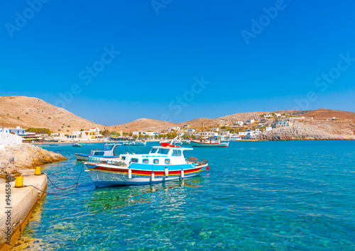 traditional fishing boats docked in the port of Pserimos island in Greece