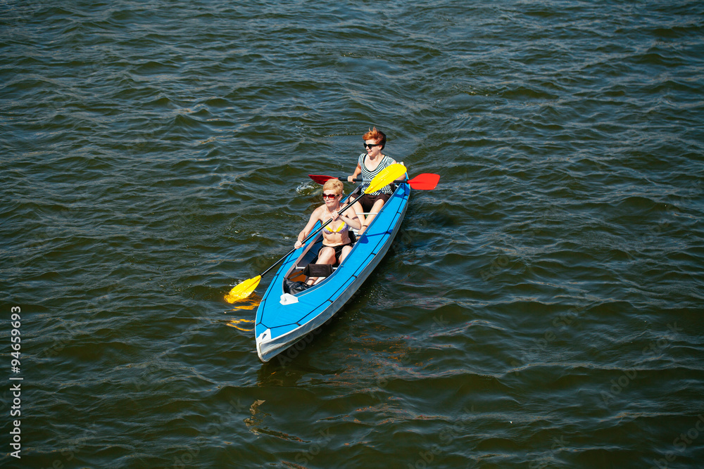 Fototapeta premium Young people in canoes. Family holiday.